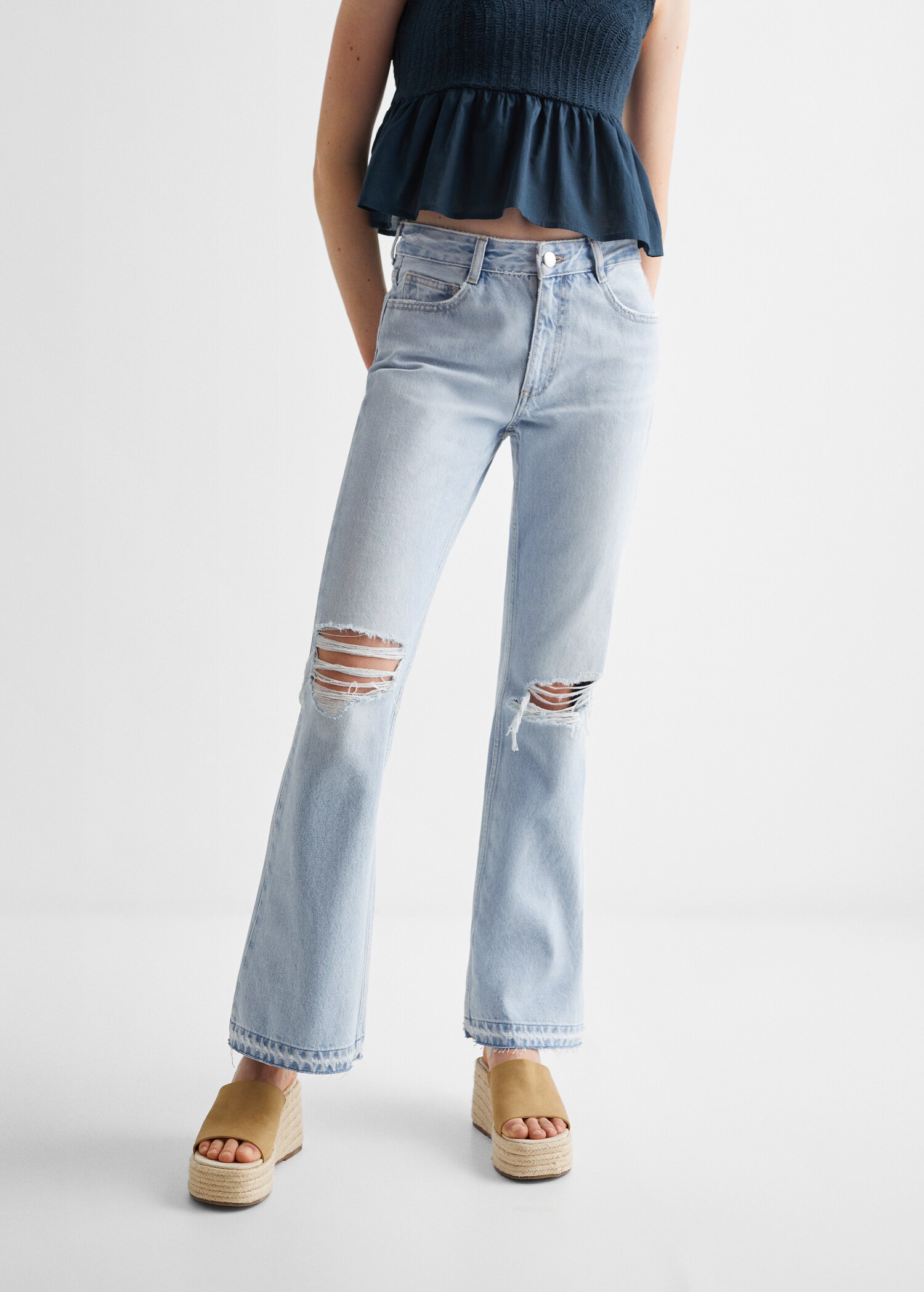 Flared jeans with decorative rips